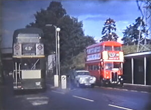 A still from a home movie by an LBM member catches one of the red RTs working a 418, opposite LH. [Eric Jones]